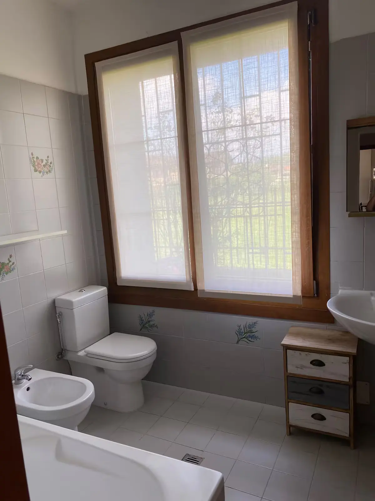 Apartment bathroom with bathtub and natural light