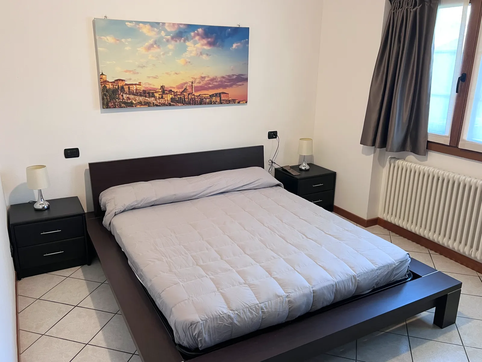 Apartment bedroom with dark wood furniture