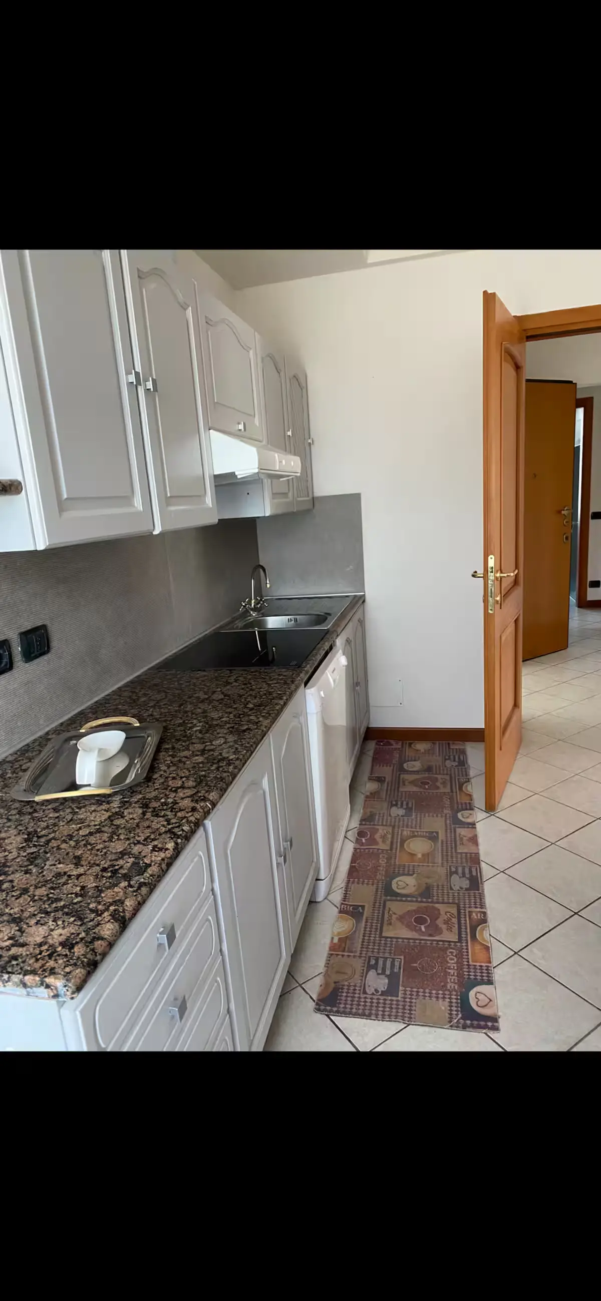 Granite kitchen countertop and white cabinets
