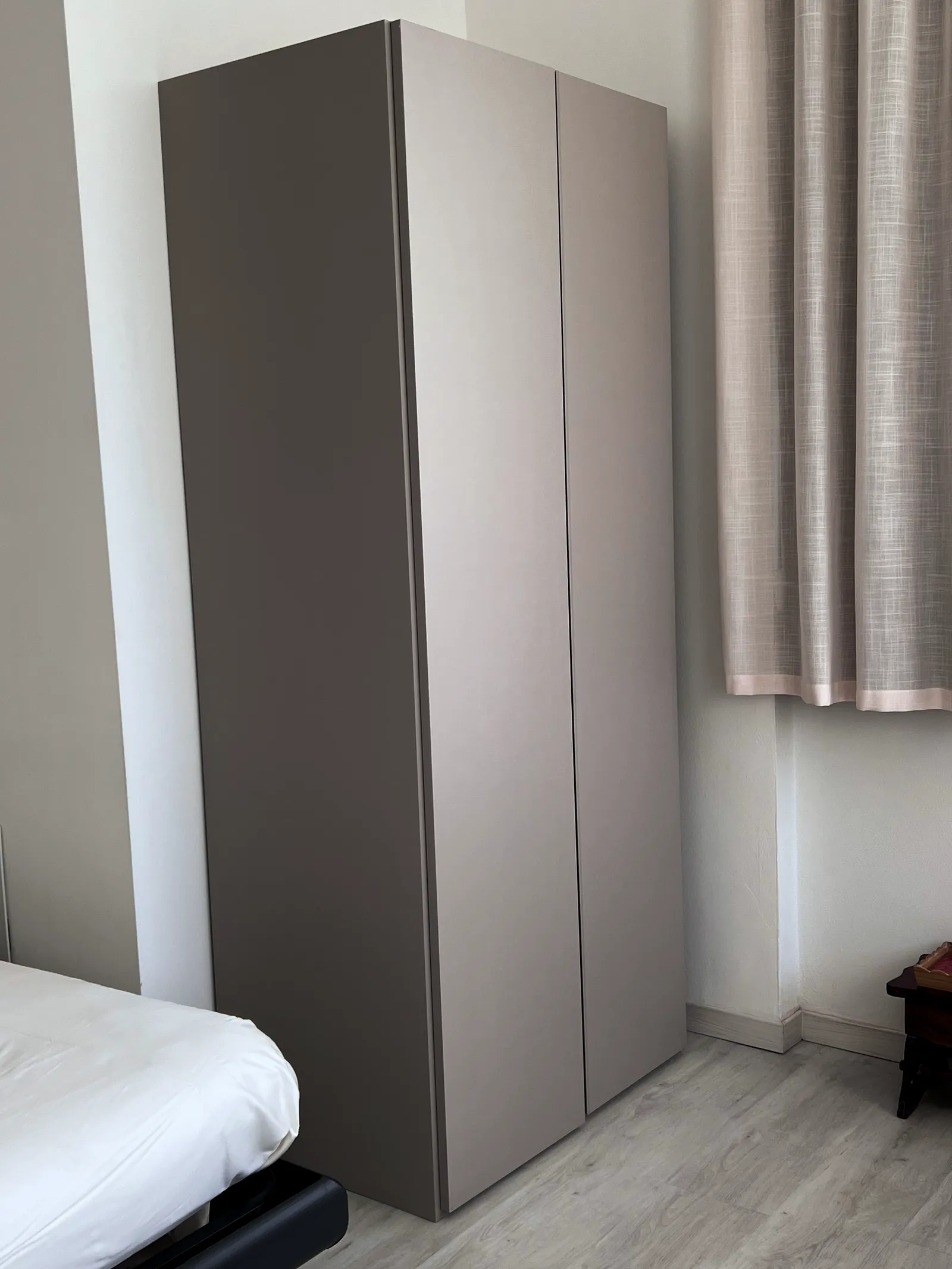 Modern gray dresser with roman shade window